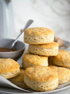 biscuits stacked on top of each other with a bowl of dipping sauce in the background