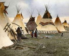 an old photo of native american teepees and people