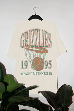 Show the love for your favorite team in this Memphis Basketball oversized tshirt that is inspired by vintage 90s NBA tshirts!- Screen print transfer that is heat pressed onto each tshirt- Tshirt is a super soft vintage wash that gets softer after each wash- Oversized fit- Sizing translation: XS/S = L , S/M = XL , L/XL = 2XL , 2XL/3XL = 3XL , 4XL/5XL = 4XL- Size up if you want a tshirt dress fit- 100% Cotton**due to screens & filters color may vary from pictures** Basketball Tournament Tshirt Designs, Vintage Basketball Tee, Vintage Sports Shirts, Vintage Basketball Shirt, Vintage Sports Tees, Team Tshirt Design, 90s Tshirt Design, Oversized Graphic Tee Outfits, 90s Graphic Tees Vintage