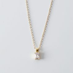 This is a dainty necklace with a small emerald cut CZ pendant. Perfect for everyday wear. Necklace Metal: 14K Gold filled Necklace Size: 16 in Pendant Metal : 18K Gold FilledPendant Size: 13 mm x 5 mm Pendant Stone: Cubic Zirconia Please allow up to 48 hours for us to prepare your order and 3-5 business days for shipping itself. Thank you darling! Elegant Gold Birthstone Necklace With Cubic Zirconia, Dainty Gold Emerald Necklace For Formal Occasions, Classic Gold Emerald Necklace With Diamond Cut, Elegant Gold Emerald Necklace With Diamond Cut, Elegant Gold Birthstone Necklace With 17 Jewels, Elegant Gold Plated Birthstone Necklace, Elegant Everyday Emerald Necklace In Gold, Elegant Gold Cubic Zirconia Birthstone Necklace, Elegant Gold Emerald Necklace For Everyday