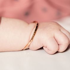 "Looking for a unique baby shower gift? Give your little ball of sunshine the cutest jewelry for every day. This will match her every outfit! M A T E R I A L Sterling Silver 14k Yellow Gold Filled 14k Rose Gold Filled S I Z E S Right out the womb 4 in Newborn hand circumference: 4 1/2 in Crawler hand circumference: 5 in Walker hand circumference: 5 1/2 in D E T A I L S Made of 12 gauge wire Packaged with a mesh pouch, perfect for gift giving. H O W ⋯ T O ⋯ S I Z E Step 1: Close your hand so that Delicate Rose Gold Keepsake Jewelry, Adjustable 14k Gold Bracelet For Birthdays, Adjustable Rose Gold Bangle For Everyday, Adjustable 14k Gold Birthday Bracelets, Stackable 14k Gold Name Bracelet, Adjustable 14k Gold Bracelets For Birthday, 14k Gold Stackable Name Bracelet Gift, Rose Gold Minimalist Jewelry For Keepsake, Rose Gold Minimalist Jewelry Keepsake