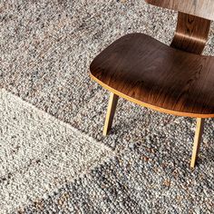 a wooden chair sitting on top of a rug