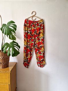 📦 FREE SHIPPING WHEN YOU BUY 3 OR MORE ITEMS  - This discount will be automatically calculated at the checkout Vintage women's red multicolored floral loose fit pants -two pockets  -elastic waist Good vintage condition  Tag: index by melrose  Size tag: L Material: 100% rayon   Measurements taken lying flat: WAIST: unstretched 39cm // 15,35 in (stretches up to 46cm // 18,11) TOTAL LENGTH: 97cm // 38,18 in  We are happy to provide additional measurements upon request. Please remember to double waist and hip for exact measurements and compare them to your own clothes. Vintage sizes do not always correlate with modern sizes and vary greatly between different brands and designers. ❗PLEASE NOTE! Our postal services requires a receiver's phone number to ensure your package gets delivered. Please Vintage Relaxed Fit Pants For Spring, Vintage Spring Loungewear Pants, Vintage Loungewear Pants For Spring, Spring Vintage Loungewear Pants, Vintage Summer Pants With Relaxed Fit, Vintage Floral Print Summer Pants, Vintage Long Pants For Summer, Vintage Relaxed Fit Summer Pants, Vintage Relaxed Fit Pants For Summer