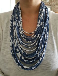 a woman wearing a blue and white necklace