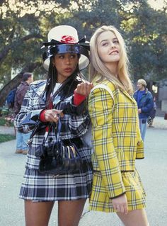 two women dressed in plaid outfits standing next to each other