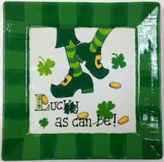 a st patrick's day plate with green boots and shamrocks on it that says lucky as can be