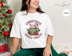 🎄 Christmas Sweet Treats T-Shirt 🍬 Get ready to spread holiday cheer with our delightful Christmas Sweet Treats T-shirt! This cozy white tee captures the joy of the season with its charming design featuring festive treats and a whimsical vibe. ⭐ PREMIUM QUALITY ⭐ - 100% Cotton. 👫 Unisex Design for Everyone 👫 All of our apparel, including the classic crewneck sweaters and Comfort Colors T-shirts, are designed to be unisex, ensuring a comfortable and stylish fit for any gender. 👕 Size and Color 👕 Size charts are located in the photo stream of every listing. If you are still unsure, message me for help! 🧼 Care Instructions 🧼 - DO inside out before wash, - DO warm/cold machine wash - DO NOT bleach, - DO NOT dry clean, - DO NOT iron directly onto the design. By following these instructi Gingerbread Shirt, Christmas Sweet Treats, Winter Tees, Cute Christmas Shirt, Crewneck Sweaters, Cute Christmas Shirts, Tshirt Women, Christmas Tops, Festive Treats