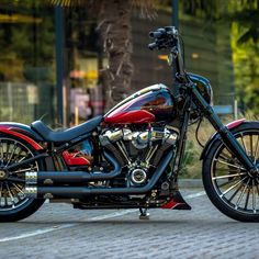 a red and black motorcycle parked on the street