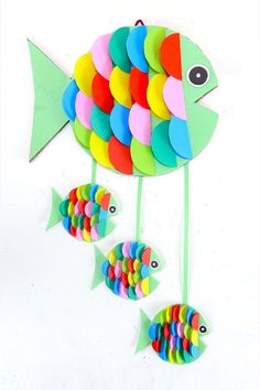 a fish made out of colored paper and some sort of magnets attached to it