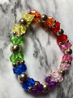 Hi! Welcome to my rainbow Glass bead bracelet!  Gift for yourself or a friend to match with any outfit! Perfect for every day wear!  The bracelet is made out of stretchy string that can be double layered for sturdiness.  The beads themselves are multicolored faceted Glass Beads of alternating after 2 with metal beads to achieve an elegant look.  Sizes are small medium and large, respectively 2,2.25,2.5 inch diameter.  Thank you for your interest! Crystal Princess, Glass Bead Bracelet, Rainbow Glass, Rainbow Beads, Glass Beaded Bracelets, Bracelet Bangle, Faceted Glass, Metal Beads, Bead Bracelet