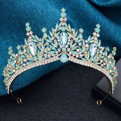 Step into royalty with our High Point Royal Queen Tiara Crowns. Featuring a stunning center medallion and fully crystal-lined bottom rim, this tiara is perfect for weddings, parties, and birthdays. Made with fine cut crystals and a sturdy metal base, it exudes elegance and luxury. Complete with veil loop ends, it's the perfect accessory for your next event. material: metal, crystal color: as shown gender: women type: tiara crown style: party, fashion, pageant, birthdays height:: around 7 cm diameter:: around 15 cm Crowns Purple, Purple And Silver Crown, Quince Crowns Silver And Purple, Silver Crown With Blue Jewels, Tiara With Purple Gems, Bridal Crown Tiara, Crystal Crown Wedding, Crown For Women