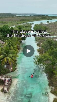 the video shows people kayaking in clear blue water with palm trees on either side