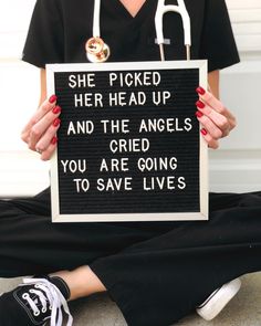 a woman holding a sign that says she picked her head up and the angels you are going to save lives