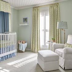 a baby's room with green walls and curtains, a white crib in the corner