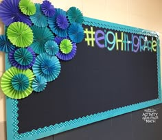 a bulletin board with paper flowers on it