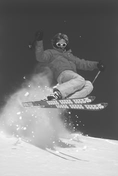 a man flying through the air while riding skis