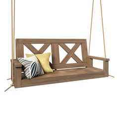 a wooden porch swing with pillows hanging from the front and back ends, on an isolated white background