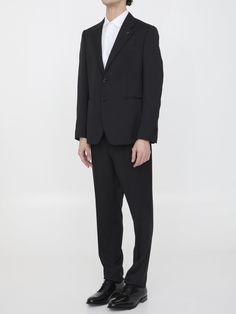 Two-piece suit in black wool. The jacket features classic lapels with brooch on lapel, single-breasted closure, two front welt pockets, a welt pocket on chest and buttoned cuffs. Straight-leg trousers with zip and button closure, two side welt pockets, two rear buttoned welt pockets and belt loops. Regular fit. The model is 184cm tall and wears size IT 50.Size nationality: IT Product number: 6734827 Product code: EQ7754SK62403999 Composition: 100% WOOL Classic Black Pantsuit For Semi-formal Occasions, Classic Black Blazer With Concealed Placket, Classic Tuxedo With Double Button Closure And Suit Collar, Classic Tuxedo With Double Button Closure, Classic Black Blazer With Hidden Button Closure, Classic Double-breasted Suit With Hidden Button Closure, Lapel Collar Tuxedo In Suiting Fabric For Work, Elegant Business Suits With Double Button Closure, Formal Pantsuit With Double Button Closure And Lapel Collar