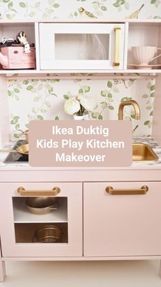 a kid's play kitchen with pink cabinets and gold accessories on the countertop