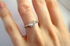 a woman's hand with a diamond ring on it