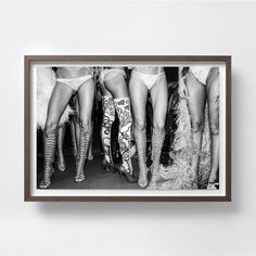 black and white photograph of women in high heeled boots with their legs spread out