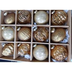 twelve gold christmas ornaments in a box