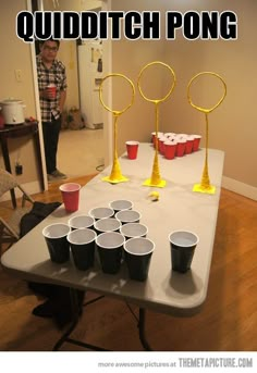 a table with cups on it that has some sort of pong game in front of it