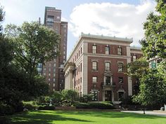 an old brick building in the middle of a park