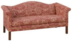 a red and gold patterned couch sitting on top of a wooden frame