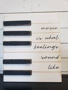 music is what feelings sound like handwritten sign on wooden planks against white painted wall