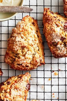 freshly baked muffins on a cooling rack next to a bowl of yogurt