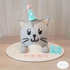 a birthday cake with a cat wearing a party hat on it's head and the number twenty two