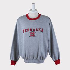 Embroidered Vintage 90s Nebraska Cornhuskers (University of Nebraska-Lincoln) Football/Basketball/Baseball/Hockey NCAA Sweatshirt 💯 SATISFACTION AND AUTHENTICITY ⭐ MEASUREMENTS (when laid flat) Size on Tag: L Length: 68cm or 27 inches Armpit to armpit: 67cm or 26.5 inches ⭐ CONDITION 9/10 (Very good) Details: No holes Material: Cotton Color: Gray Brand: Lee Sport 🔷 Please give us your phone no. together with address after you purchased. 🔷Please keep in mind that our items are vintage so they Huskers Football, Husker Football, Hockey Clothes, Football Sweater, Nebraska Huskers, Nebraska Cornhuskers, Embroidered Crewneck, Fun Sweatshirts, Football And Basketball