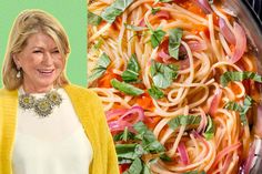 a woman standing in front of a plate of pasta and veggies on a green background