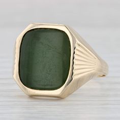 Gemstone Information: - Natural Nephrite Jade - Size - 13.5 x 11.5 mm  Cut - Cushion Tablet Color - Green  Please note there is a bit of surface wear. Metal: 10k Yellow Gold Weight: 7.2 Grams  Stamps: 10k Falcon Face Height: 16.6 mm  Rise Above Finger: 3.7 mm Band / Shank Width: 2.4 mm This ring is a size 11, but it can be resized down 3 size for a $20 fee or up 2 sizes for a $30 fee. Please note that sizing up will give the band an oval shape, but this will not affect the wear or comfort of the ring. If you would like your ring resized, please select the appropriate fee from the listing below in order to pay the sizing fee: https://www.etsy.com/listing/781388346/ring-sizing-service-fee Each piece is thoroughly examined and refinished as needed by our professional jewelers, graded by our i Heirloom Green Jade Jewelry, Gold Jade Ring With Polished Finish, Collectible Yellow Gold Jade Jewelry, Green Carved Jade Rings, Yellow Gold Jade Cabochon Ring, Nephrite Jade, Jade Ring, Jade, Favorite Jewelry