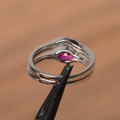 It is a lab ruby ring. The main stone is 6 mm*8 mm oval cut.weight about 1.75 carats. The basic metal is sterling silver and plated with rhodium. To change the metal to a solid gold (white/rose) or platinum is also available, please ask for a quotation if you want. You can also go to my shop Home for more elegant rings: https://www.etsy.com/shop/godjewelry?ref=hdr_shop_menu Ruby is July birthstone More ruby rings: https://www.etsy.com/shop/godjewelry?search_query=pink+quartz Customization is alw Silver Marquise Cut Ruby Promise Ring, Silver Marquise Cut Ruby Ring, Silver Ruby Ring With Marquise Cut, Elegant Silver Ruby Ring With Marquise Cut, Marquise Cut Ruby Ring In Silver, Silver Marquise Cut Ruby Jewelry, Silver Ruby Jewelry With Marquise Cut, Oval Ruby Stackable Rings For Wedding, Oval Ruby Stackable Wedding Rings