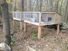 a wooden structure in the woods with air conditioners on it