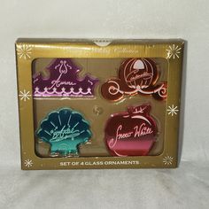 four assorted glass ornaments in a box