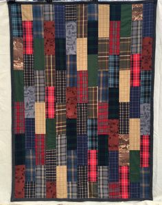 a patchwork quilt hanging on the wall