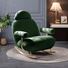 a green chair sitting on top of a rug next to a lamp and potted plant