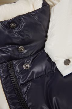 Instantly recognizable, the Parana down jacket is crafted from glossy nylon laqué. Characterized by squared quilting, contrast color lining and a detachable hood, the short puffer is a practical piece that goes from the school yard to the playground. Luxury Blue Hooded Outerwear, Luxury Blue Puffer Jacket For Winter, Blue Hooded Puffer Jacket With Detachable Hood, Luxury Blue Winter Puffer Jacket, Luxury Blue Puffer Outerwear, Luxury Hooded Outerwear For Outdoor, Navy Hooded Puffer Jacket With Pockets, Blue Hooded Puffer Jacket With Padded Collar, Navy Hooded Jacket With Drawstring For Winter