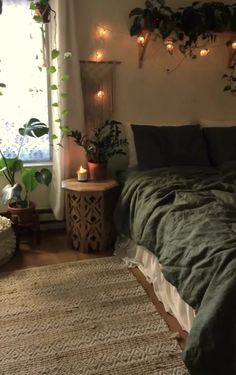 a bed sitting in a bedroom next to a window with plants on the wall above it