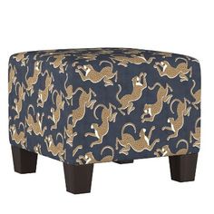 a blue and gold patterned ottoman with wooden legs