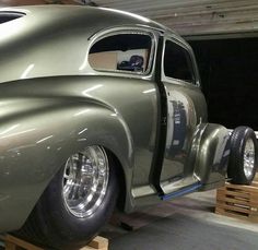 an old car is being worked on in a garage