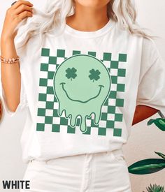 Time to show your Irish pride with this amazing retro St Patrick's Day T-shirt! Featuring a bold design with a retro smiley face on a checkered background, this St Patricks Day tee is perfect for any fan of the holiday. Be the most festively dressed at the Paddy pub crawl and family gatherings! 🍀  Comfort Colors® Lucky Vibes T-shirt, St Patricks Retro Smiley, St Patricks Day T-shirt, Retro Lucky Smile Faces T-shirt, Patrick Day T-shirt SIZE UP for an OVERSIZED FIT (see size chart in listing pho Retro Green T-shirt For Fans, St. Patrick's Day Graphic Print Crew Neck Top, Pop Culture Green Tops With Letter Print, Green Pop Culture Graphic Print Tops, St. Patrick's Day Graphic Tee With Graphic Print, St. Patrick's Day Graphic Tee With Print, St. Patrick's Day Graphic T-shirt, St. Patrick's Day Graphic Tee, Fun Green T-shirt With Graphic Print