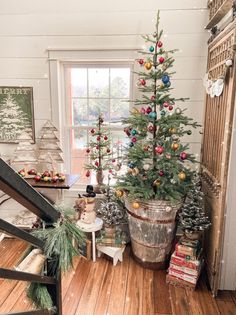 a small christmas tree in a bucket next to a window with the words vintage christmas tips on it