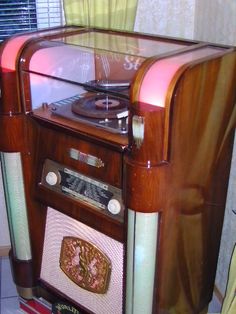 an old fashioned record player sitting on top of a table