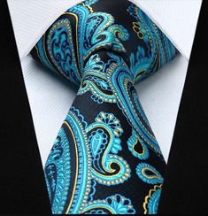 A pop of bright blue highlights adorn this paisley tie! Behind the bright blue is a deep blue and gold accent that create a 3D looking paisley tie! Choose From: Single Tie Tie, Square Material of Tie and Square: 100% Silk Dimensions of Pocket Square: 10.5” x 10.5” Inches Width of Tie: 3.4” Inches Length of Tie: Regular (60”) XL (63”) Pattern On Fabric: Paisleys Color Of Fabric: Aqua, Yellow, Blue Blue Wedding Neckwear With Ties, Blue Ties For Wedding Neckwear, Elegant Multicolor Paisley Print Ties, Blue Paisley Print Ties For Black Tie Occasion, Blue Paisley Print Tie For Black Tie Events, Blue Paisley Print Ties For Black Tie Events, Elegant Blue Neckwear With Ties, Blue Paisley Print Tie, Blue Paisley Print Standard Tie