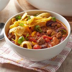 a white bowl filled with chili and tortilla chips