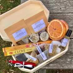 an open wooden box filled with lots of different types of food and spices on top of a picnic table